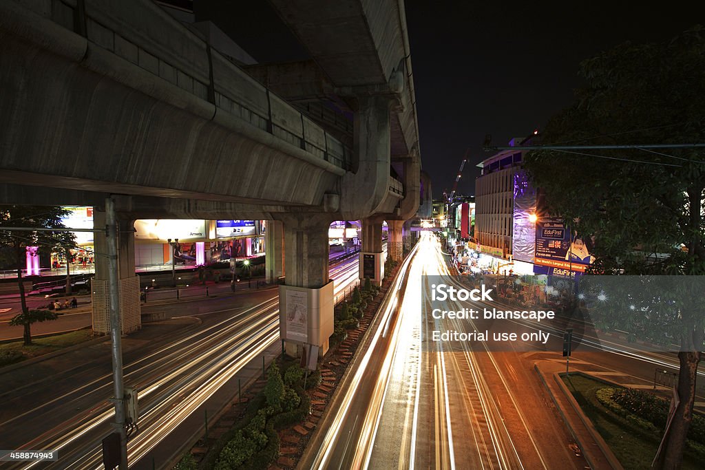 Light trails on RamaI street at Pathumwan junction Bangkok, Thailand - March 16, 2013: Light trails on RamaI street at Pathumwan junction on March 16, 2013 in Bangkok, Thailand. Pathumwan junction is main shopping center of MBK, Siam Discovery, Siam Center, Siam Paragon. Asia Stock Photo