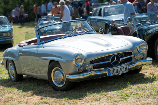 Bad KAnig, Germany - July 14, 2013: A Mercedes-Benz 190 SL Roadster (W 121 II) sits in a meadow. at a classic car meeting. The car was produced from 1955 until 1963. Mercedes Benz is German car manufacturer and part of the Daimler AG.