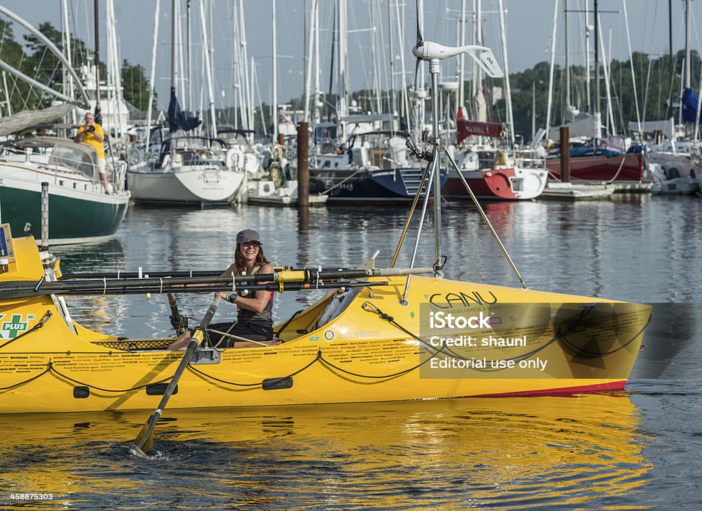 Mylène Paquette - Trans-Atlantic Crossing Halifax, Canada - July 6, 2013: MylAne Paquette smiles while taking the first few strokes of her solo rowing adventure as she departs from the Royal Nova Scotia Yacht Squadron on a 2700 nautical mile journey to Lorient, France. 2013 Stock Photo