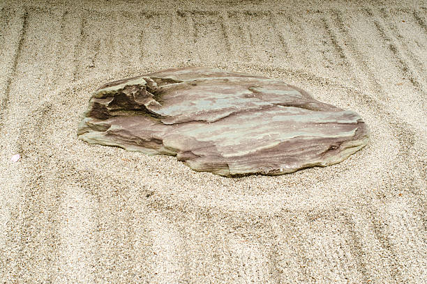 Kyoto, Japan - December 2, 2011: Sand and big stone in a zen garden
