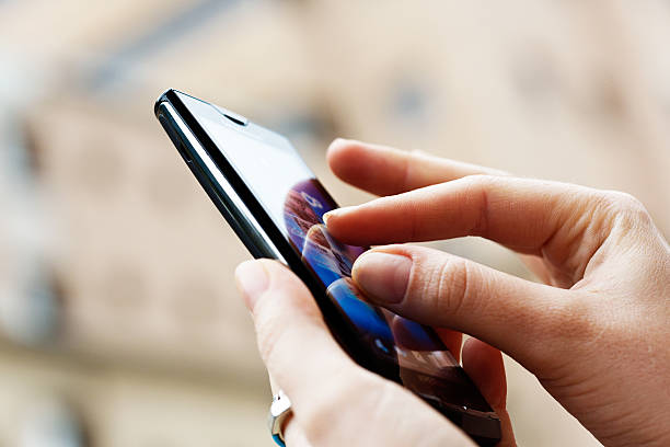 Cape Town, South Africa - October 3, 2012: A woman's hands touch the screen of a Sony Ericsson Xperia X10 Android smart phone, \