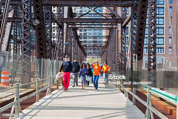 Love Local Walking Across A Pedestrian Bridge In Boston Stock Photo - Download Image Now