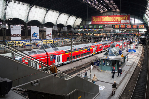 Hamburg, Germany - September 17, 2011: Trains on the central railway station of Hamburg wait for departure. People wait for trains.