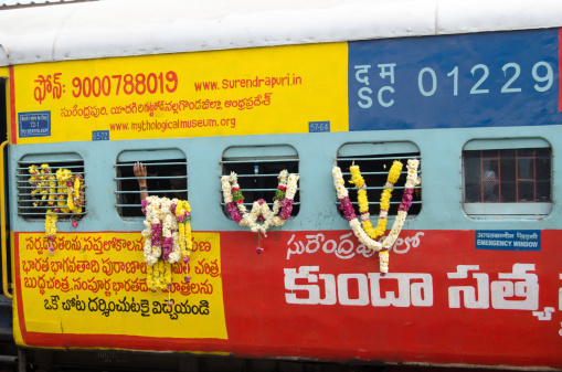 Hyderabad, India - January 8, 2013: A railway carriage carrying Hindu priests laced with floral garlands.