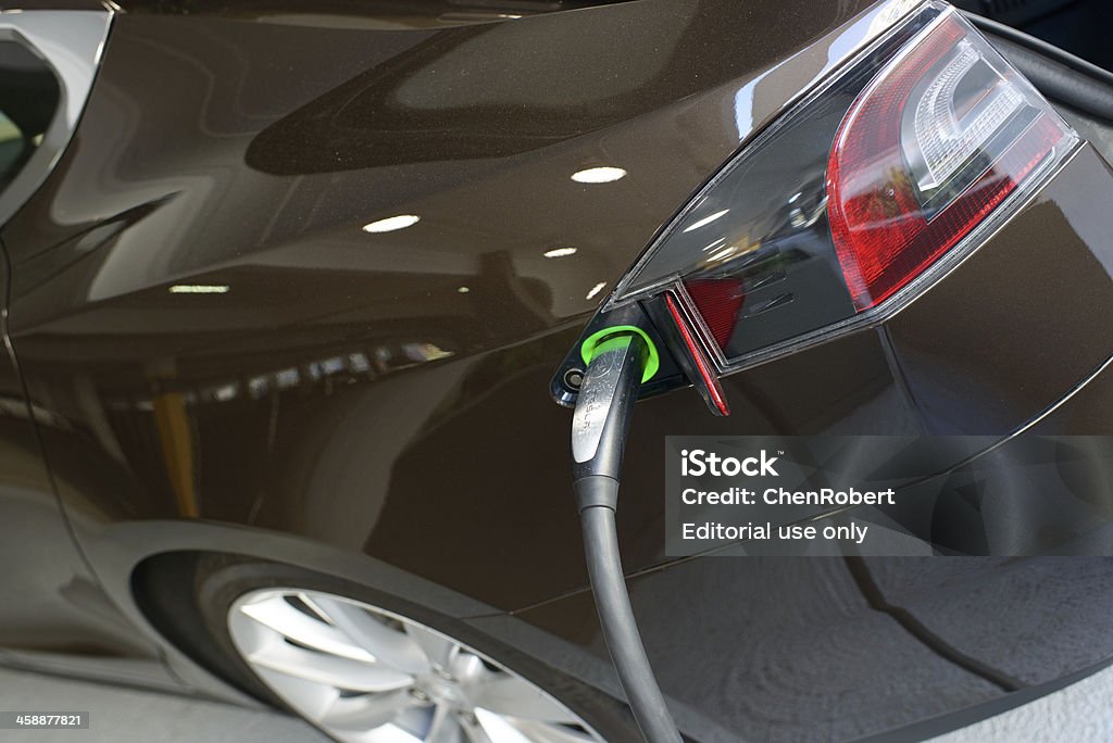 Charging Tesla Motors Model S San Jose, California, USA - March 11, 2013: A closeup of a Tesla Motors Model S charging at a public parking garage. Alternative Fuel Vehicle Stock Photo