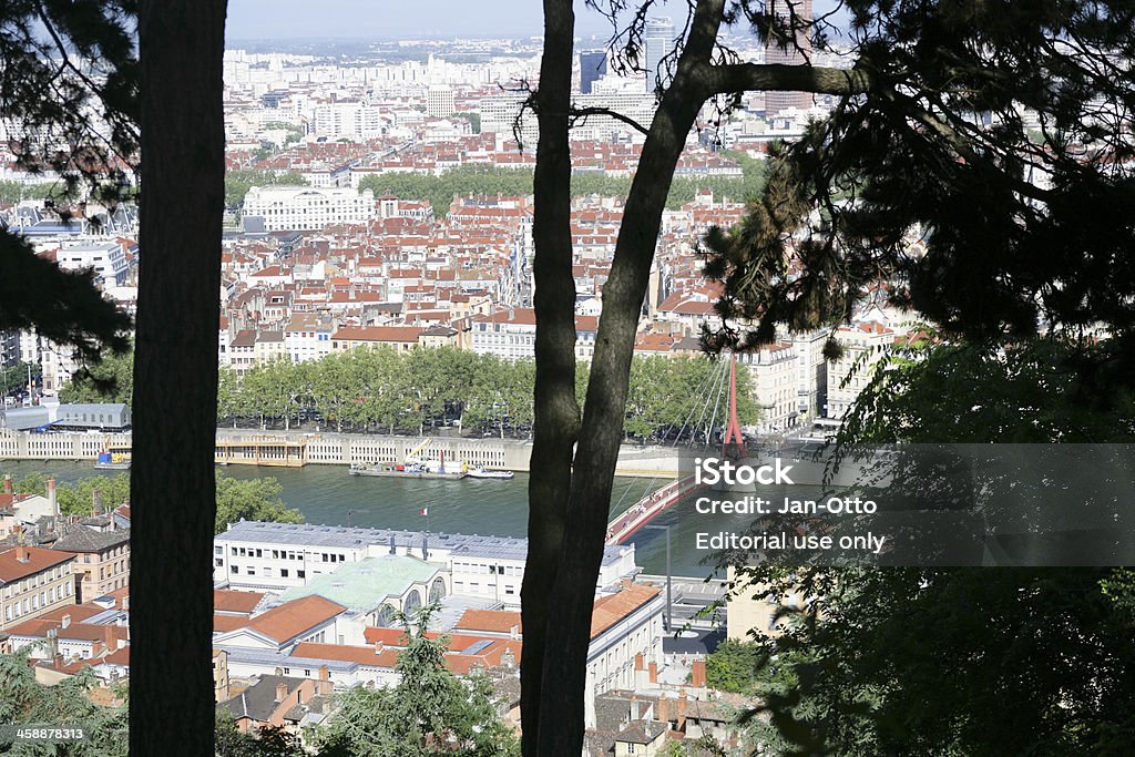 Lyon and Saone river Lyon, France - July 27, 2013: View from the hill "La FourviAre" on the city of Lyon / France in summertime. In front you can see the river "La Saone". The bridge "Paserrelle du Palais de Justice" is crossing the river. Lots of cafes are surrounding the scenery. The trees in front do belong to the park of the church Notre Dame de la Fourviere. Apartment Stock Photo