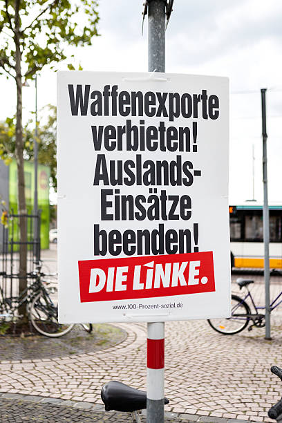 Election campaign billboard of DIE LINKE / Bundestagswahlkampf 2013 Darmstadt, Germany - August 13, 2013: Election campaign billboard of german political party DIE LINKE in the city center of Darmstadt. Germany faces federal elections scheduled for September 22. Some passersby and road users in the background. german federal elections photos stock pictures, royalty-free photos & images