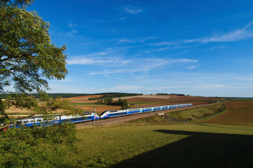 Sens, France - 19 September 2010: A french high speed train passing through a field.