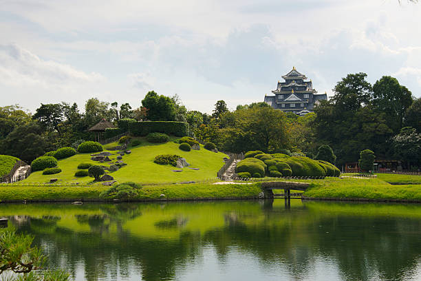 Koraku-en garden and castle in Okayama, Japan Okayama, Japan - October 10, 2012: view of KAraku-en garden with Okayama's castle emerging in the background. This garden was built in 1700 by Ikeda Tsunamasa, lord of Okayama, and is currently considered one of the Three Great Gardens of Japan, along with Kenroku-en and Kairaku-en. okayama prefecture stock pictures, royalty-free photos & images