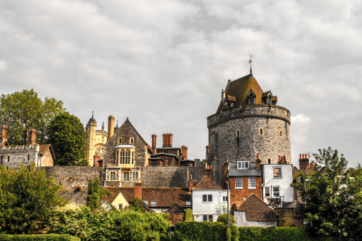 Windsor, United Kingdom - June 26, 2013: View of homes and a medieval watchtower in Windsor, United Kingdom.