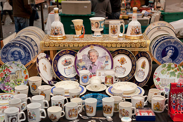 kingdom souveniers are at sale in london england london, england - November 11, 2011: Queen elizabeth pictured plates and kingdom materials souveniers are at sale in market place of london england london memorabilia stock pictures, royalty-free photos & images