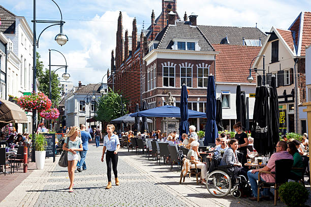 Arnhem Arnhem, the Netherlands - August 8, 2013: People sitting on a terrace in the inner city of Arnhem. Around the square are several shops, the square is called Jansplaats. Two young girl walking in the street. arnhem photos stock pictures, royalty-free photos & images