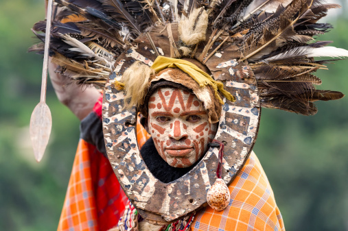 Thompson Falls, Kenya - November 30, 2011: Proud member of the Kikuyu tribe with painted face and headdress posing for visitors at Thompson Falls near Rift Valley.