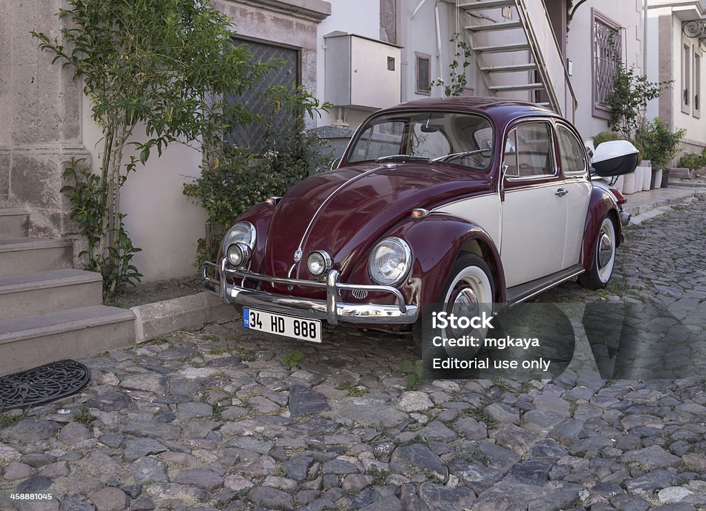 Volkswagen Beetle Ayvalik, Turkey - July 25, 2013: Two color Volkswagen Beetle is parked on street in Ayvalik, Turkey. This car is officially called the "Volkswagen Type 1" and manufactured by the German auto maker Volkswagen (VW) from 1938 until 2003. VW Beetle designed by Ferdinand Porsche.AyvalAk is a seaside town and it's a district of the BalAkesir Province. Ayvalik is on the northwestern Aegean coast of Turkey, facing the Greek island of Lesbos. Beetle Stock Photo