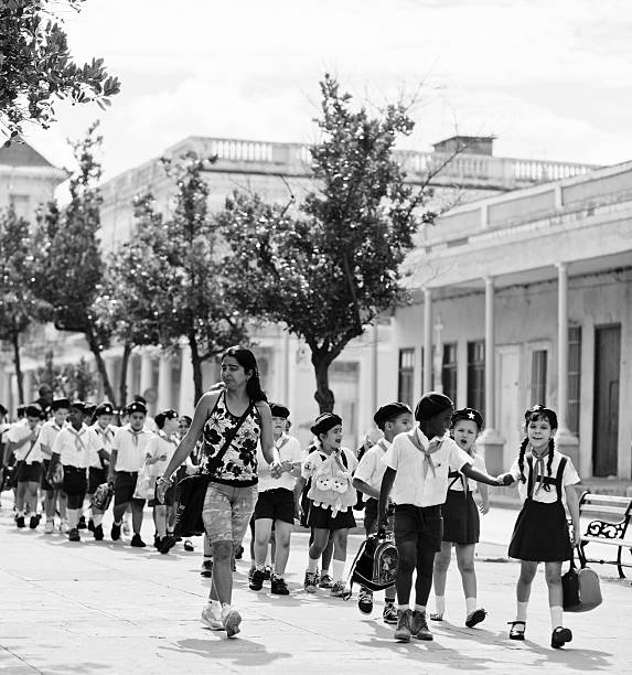Cienfuegos, Cuba - december 22, 2012: Cuban pioneers from Junior school on the street of famous tourist destination Cienfuegos City (UNESCO Heritage).