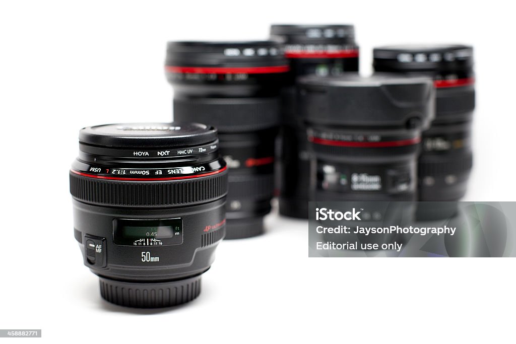 Canon EF 50mm f/1.2 L USM Lens New York, USA - March 20, 2013: 50mm f/1.2 Canon EF Mount Lens isolated on a white surface and with other Canon lens at the background. Aperture Stock Photo