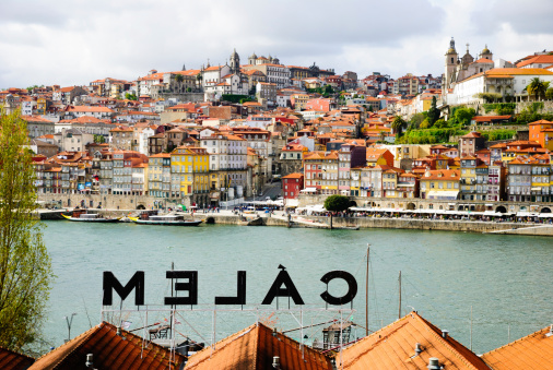 Porto, Portugal - April 21, 2012: View towards Porto over the Calem wine cellar roof. Calem is one of recognizable Porto Wine companies..