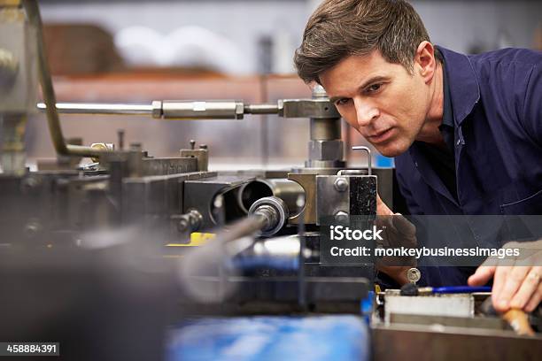 Factory Engineer Operating Hydraulic Tube Bender Stock Photo - Download Image Now - Machinery, Engineer, Factory