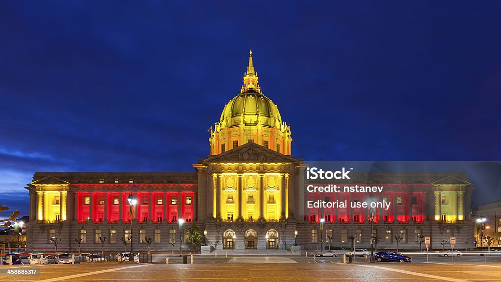 San Franicisco City Hall in Red and Gold San Francisco, USA - January 12, 2013: City Hall in red and gold light in honor of the 49ers hosting an NFL playoff game against the Green Bay Packers on January 12, 2013. American Culture Stock Photo