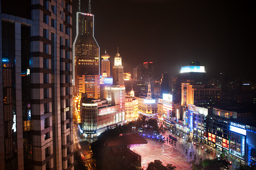 Shanghai, China - October 25, 2012: Famous East Nanjing  Road of Shanghai at night with illuminated signs and pedestrians.