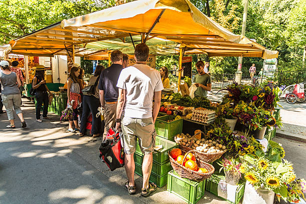 Berlin, Germany - August 17, 2013: Market in Prenzlauer Berg, Kollwitzplatz. Weekly market for fresh, quality and healthy products. People speaking and relaxing in summer.