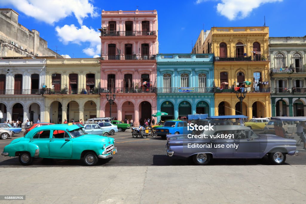 Vintage cars moving on the streets of colorful Havana Havana, Сuba - February 12, 2013: Vintage cars moving on the streets of colorful Havana. A great variety of old cars exist In Cuba. On the streets cars from the first half of the 20th century can be found in magnificent conditions, which takes back in history and feel the old atmosphere of the cities. Havana Stock Photo