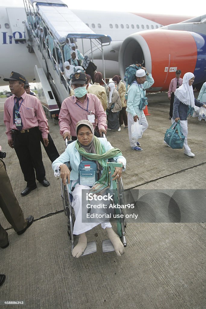 Muslim Pilgrim Going Home Boyolali, Indonesia - December 13, 2008: Officer helped sick Indonesian pilgrims as they disembark from their plane after returning home from a month-long Hajj pilgrimage to Mecca in Saudi Arabia at Adi Sumarmo Airport, Boyolali, Central Java, Indonesia Central Java Province Stock Photo