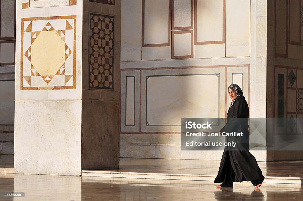 Syrian woman in Damascus' Umayyad Mosque Damascus, Syria - June 3, 2010: A Syrian woman walks through the sunlit courtyard of the Umayyad Mosque in the old city of Damascus. Adult Stock Photo