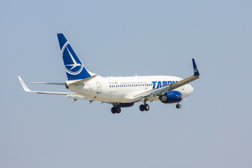Bucharest, Romania - July 27, 2013: Boeing 737 of TAROM company climbs after take off on July 27, 2013 in Bucharest, Romania. TAROM owns one of the youngest fleet in Europe, consisting of 24 aircrafts.