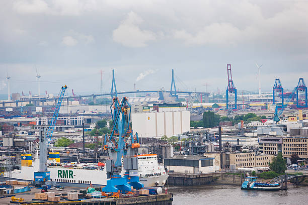 Hamburg harbour Hamburg, Germany - May 27, 2013: Part of the huge harbour of Hamburg in Germany. In the back you can see the famous "Koehlbrandbruecke", a huge bridge crossing the "Koehlbrand", a part of the river Elbe. On right hand side you can see the cranes of the Container terminal "Altenwerder". In front ships of the "Steinwerder Hafen" and a small ferry from the public travelservice "HVV" with passengers hopping off at this point (bottom/right). köhlbrandbrücke stock pictures, royalty-free photos & images