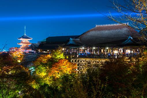 Kyoto, Japan - November 19, 2012: Tourists atop the famed stage at Kiyomizu Dera during the annual fall light show. The temple is one of Japan's most celebrated holy sites.