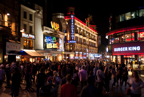 London, UK - August 16, 2013: people enjoy the Friday nightlife in Leicester Square. Leicester Sq is a pedestrianised square in the West End and is the prime location in London for world leading film premieres.