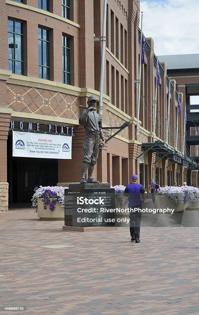 Coors Field Denver, Colorado, USA - August 11, 2013: Streetside view of people walking near statue of The Baseball Player at Coors Field, home to the MLB Colorado Rockies and named after the brewing company from Golden, Colorado. Baseball - Sport Stock Photo