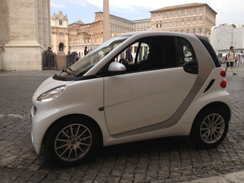 Vatican, Vatican City State - July 29, 2013: Smart Car parked in Vatican Streets. Photo taken from Vatican City State. Photo taken with Apple iPhone.