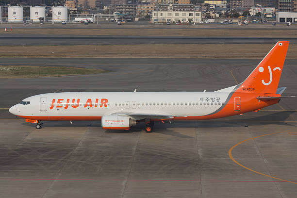 Jeju Air Boeing 737 Fukuoka, Japan - March 12, 2013 : Jeju Air Boeing 737 taxiing at Fukuoka Airport in Japan. Jeju Air is a low cost airline based in Jeju City, Jeju-do, South Korea. jeju city stock pictures, royalty-free photos & images