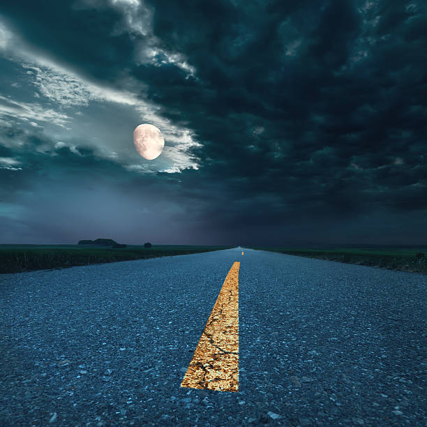 istock Driving on asphalt road at night towards the moon 458889837