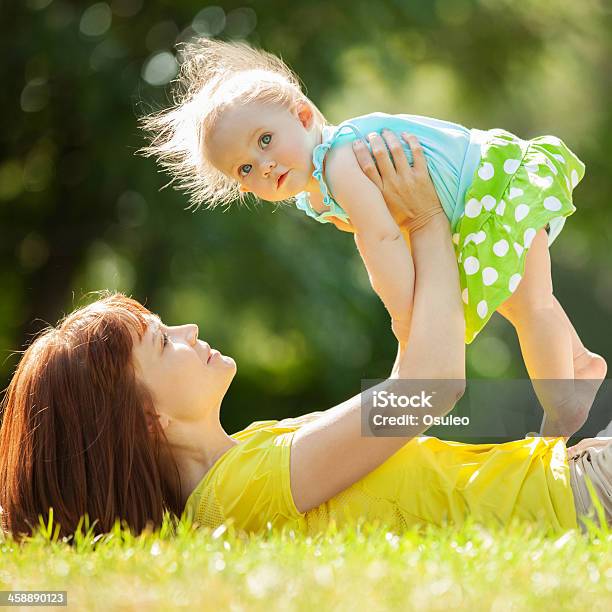 Happy Mother And Daughter In The Park Stock Photo - Download Image Now - Adult, Affectionate, Baby - Human Age