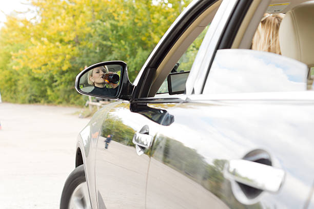 istock Woman weaving her car as she drinks alcohol 458892195
