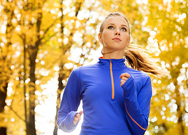 istock Attractive woman jogging outdoors in autumn 458892877