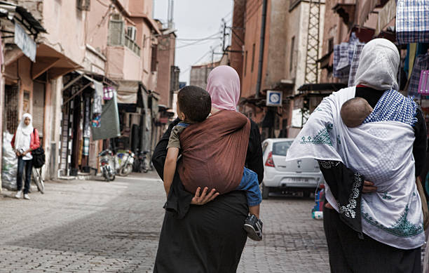 Marrakesh, Morocco - October 18, 2011: Women Carrying their children