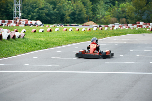 Little karting racer on the outdoor track