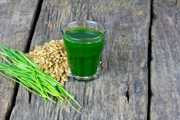 istock Wheat grass juice on wood background 458903409