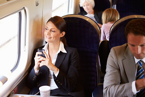 istock Businesswoman Commuting To Work On Train Using Mobile Phone 458905827