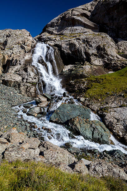 istock Waterfall flowing from Ala-Kul lake. Kyrgyzstan 458907061