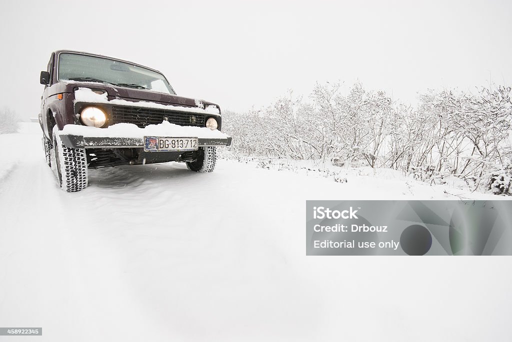 Lada Niva "Belgrade, Serbia - December 26, 2007: Legendary Russian 4wd Lada Niva in action during snow; Lada Niva is produced by Soviet/Russian car maker ""Avto Vaz""; Official model name for this car is VAZ-2121; first serial production was started back in 1977 year, and with minor changes of engine and design, is still in produce; main characteristics for this car are low price and superior performances in heavy road / off road conditions" 4x4 Stock Photo