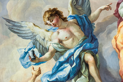 Vienna, Austria - January 9, 2012: Detail of a painted angel, part of the 18th Century fresco on the interior of the main dome of Karlskirche (St. Charles's Church) in Vienna.  The fresco was painted by Johann Michael Rottmayr and Gaetano Fanti, and illustrates the Christian virtues of faith, hope and love.