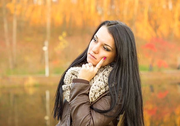 istock Young pretty woman in autumn park 458922839