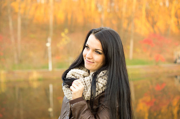 istock Young pretty woman in autumn park 458922883