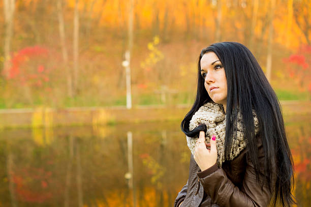 istock Young pretty woman in autumn park 458922929
