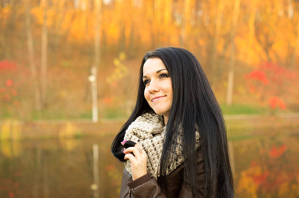 istock Young pretty woman in autumn park 458922953